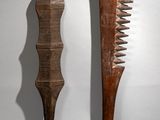 pair of wooden combs on a white background with a shadow