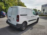 the back of a white van parked in a parking lot