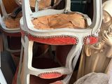 a stack of chairs and a chair in a room filled with furniture