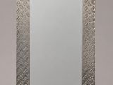un grand miroir argenté orné d'un motif en chevrons