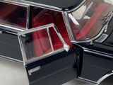 a close up of a black car with red seats