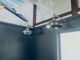 two lights hanging from the ceiling in a room