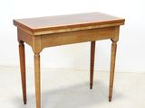 a small table with a wooden top on a white floor