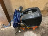a black tank with a hose and a blue hose on the ground