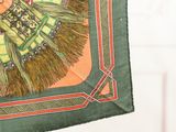 a green and orange scarf with a picture of a woman on it