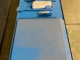 a close up of a blue platform with a piece of metal on it