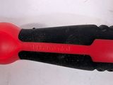 a red and black object on a white surface