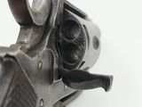 a close up of a gun on a white surface