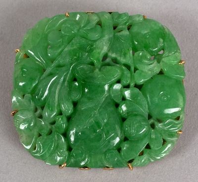 a close up of a green broochee with leaves on it