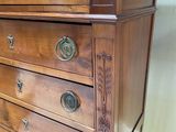a wooden chest of drawers with many drawers on top of it