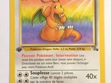 pokemon card with a picture of a dragon sitting on top of it