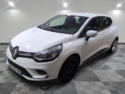 la voiture blanche est garée sur un sol en damier dans le garage
