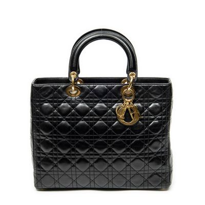 a black handbag with gold hardware on the handle