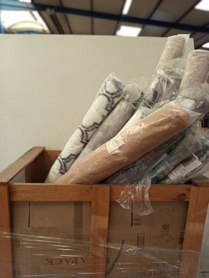 many rolls of toilet paper in a wooden box