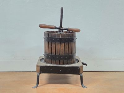a small wooden machine that is sitting on a wooden floor