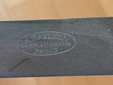 a close up of a knife on a wooden table