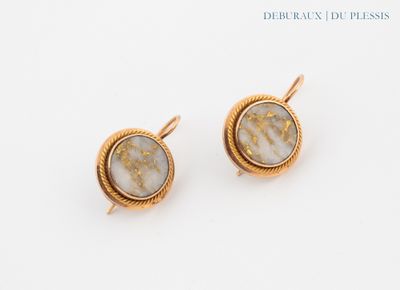a pair of earrings with gold and white marbles on a white surface