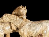two horses that are standing next to each other