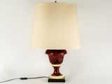 a red lamp with a white shade on top of it