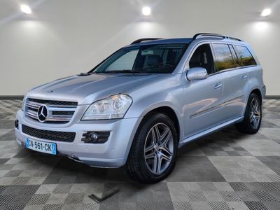 the mercedes gl is parked on a checkered tile floor