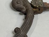 a metal door handle and a door handle on a white surface