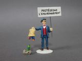 a figurine of a man holding a sign next to a bird