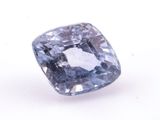 a close up of a blue diamond on a white surface