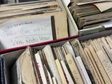 a lot of old papers in a box on a table