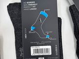 two pairs of socks on a table with a price tag