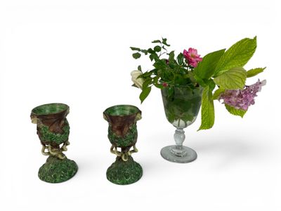 three vases with flowers in them sitting next to each other