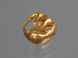 an image of a gold ring sitting on top of a table