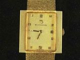 an image of a close up of a wrist watch on a black surface