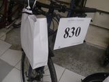 a bike with a bag attached to the back of it