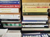 many books stacked on top of each other on a table