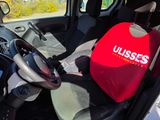 the interior of a car with a red seat cover and steering wheel