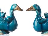two blue birds that are sitting on top of each other