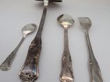 five spoons and two spoons sitting on a table