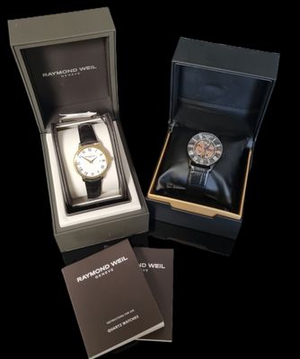 a box with a watch inside of it on a black surface