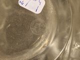 a glass bowl with a label on it sitting on a counter