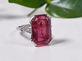 a close up of a pink tourmaline ring with a leaf in the background