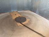 a large metal object in the middle of a concrete floor