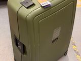 un bagage posé par terre à côté d'un caddie