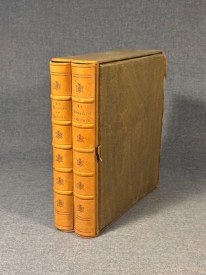 an old book with three spines sitting on top of a table