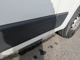 a close up of a white van with a flat tire