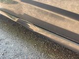 a close up of a car ' s door handle on the side of the road