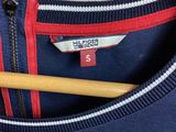 navy blue t - shirt with red and white stripes and a wooden knitting needle