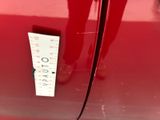 a sticker on the door of a red car that has a sticker on it