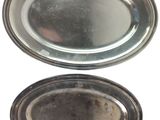 two silver plates with a silver rim and a silver plate with a silver rim