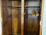 a wooden armoire with shoes on it in a room