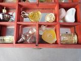 a red box filled with different types of perfumes